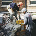 concrete slab being broken piece by piece usng the 